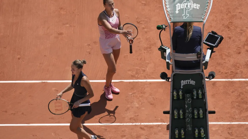 Aryna Sabalenka of Belarus, top, and Ukraine's Marta Kostyuk, left, refused to shake hands at the end of their first round match of the French Open tennis tournament at the Roland Garros stadium in Paris, Sunday, May 28, 2023. Sabalenka won in two sets, 6-3, 6-2. (AP Photo/Christophe Ena)