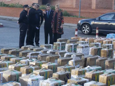 Madrid regional government delagate Cristina Cifuentes, right and the chief of Spain's national police force, Ignacio Cosido 2nd right look at part of a haul of hashish and marijuana in Madrid, Wednesday Dec. 26, 2012. Spanish police have seized 11 metric tons (12.1 U.S. tons) of hashish smuggled from Morocco on trucks with tanks rigged to hide the drugs. Thirty five people were arrested in what was described as the breakup of a major smuggling ring that fed the European market. Authorities said in a statement Wednesday that the hashish was sent to a Madrid suburb for distribution to countries including Belgium, Britain, France and Holland. (AP Photo/Paul White)