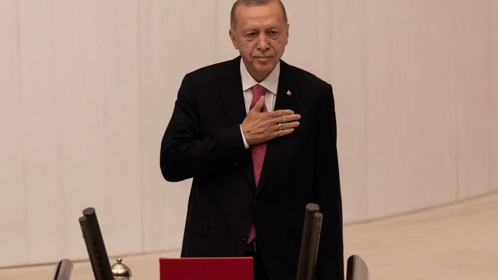 Turkish President Tayyip Erdogan greets members of the parliament and guests as he arrives to take his oath after his election win in Ankara, Turkey, June 3, 2023. REUTERS/Umit Bektas