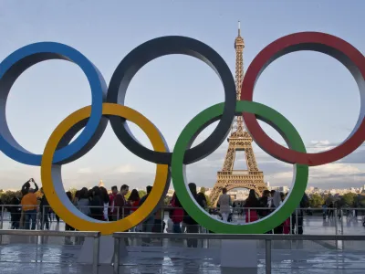 FILE - The Olympic rings are set up in Paris, France, Thursday, Sept. 14, 2017 at Trocadero plaza that overlooks the Eiffel Tower, a day after the official announcement that the 2024 Summer Olympic Games will be in the French capital. French investigators searched the headquarters of Paris Olympic organizers on Tuesday in a probe into suspected corruption, according to the national financial prosecutor's office. (AP Photo/Michel Euler, File)