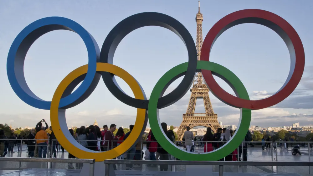FILE - The Olympic rings are set up in Paris, France, Thursday, Sept. 14, 2017 at Trocadero plaza that overlooks the Eiffel Tower, a day after the official announcement that the 2024 Summer Olympic Games will be in the French capital. French investigators searched the headquarters of Paris Olympic organizers on Tuesday in a probe into suspected corruption, according to the national financial prosecutor's office. (AP Photo/Michel Euler, File)