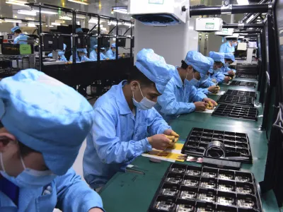 ﻿In this Feb. 13, 2020, photo released by Xinhua News Agency, workers wearing masks labor at a factory for Chinese telecommunications company OPPO in Dongguan, in southern China's Guangdong Province. Factories in China, struggling to reopen after the coronavirus shut down the economy, face a new threat from U.S. anti-disease controls that might disrupt the flow of microchips and other components they need. For most people, the new coronavirus causes only mild or moderate symptoms. For some it can cause more severe illness. (Chen Yuxuan/Xinhua via AP)