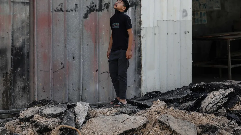 05 July 2023, Palestinian Territories, Jenin: A Palestinian child inspects damages at the Jenin refugee camp after the large-scale Israeli military operation in the West Bank town of Jenin. 12 Palestinians were killed and more than 120 wounded. Photo: Ayman Nobani/dpa