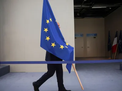A person carries the EU flag during a NATO leaders summit in Vilnius, Lithuania July 12, 2023. REUTERS/Kacper Pempel