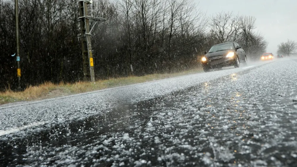 Hailstorm on the road in a summer day