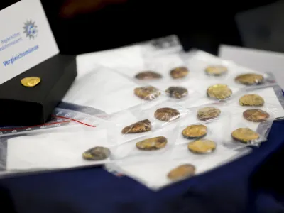 Comparison coins are presented during a press conference held by the Bavarian State Criminal Police Office and the Munich Public Prosecutor's Office on the arrests in the Manching gold treasure theft case in Munich, Germany, Thursday July 20, 2023. Investigators looking into the theft of hundreds of ancient gold coins from a German museum have found lumps of gold that appear to result from part of the treasure being melted down, but still hold out hope of finding the rest intact, officials said Thursday. (Uwe Lein/dpa via AP)