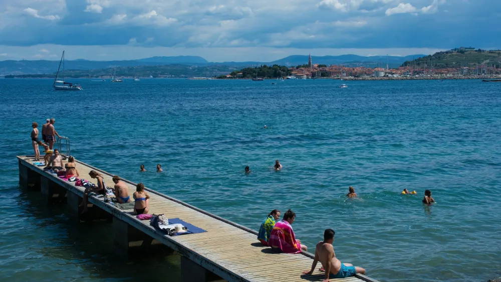 Izola, Sovenia - 10th July 2022. Locals and tourists enjoy the sun on the Adriatic coast of Slovenia near Izola