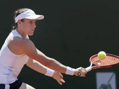 ﻿Tamara Zidansek from Slovenia returns a ball to Clara Burel from France during the final match at the tennis WTA International Ladies open in Lausanne, Switzerland, Sunday, July 18, 2021. (Cyril Zingaro/Keystone via AP)