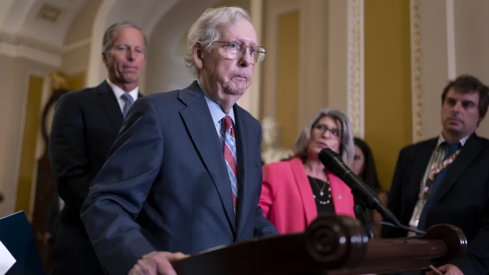 Senate Minority Leader Mitch McConnell, R-Ky., joined at left by Sen. John Thune, R-S.D., and Sen. Joni Ernst, R-Iowa, seems to freeze at the microphones as he arrived for a news conference at the Capitol in Washington, Wednesday, July 26, 2023. McConnell went to his office for a few minutes and returned to speak with reporters. (AP Photo/J. Scott Applewhite)