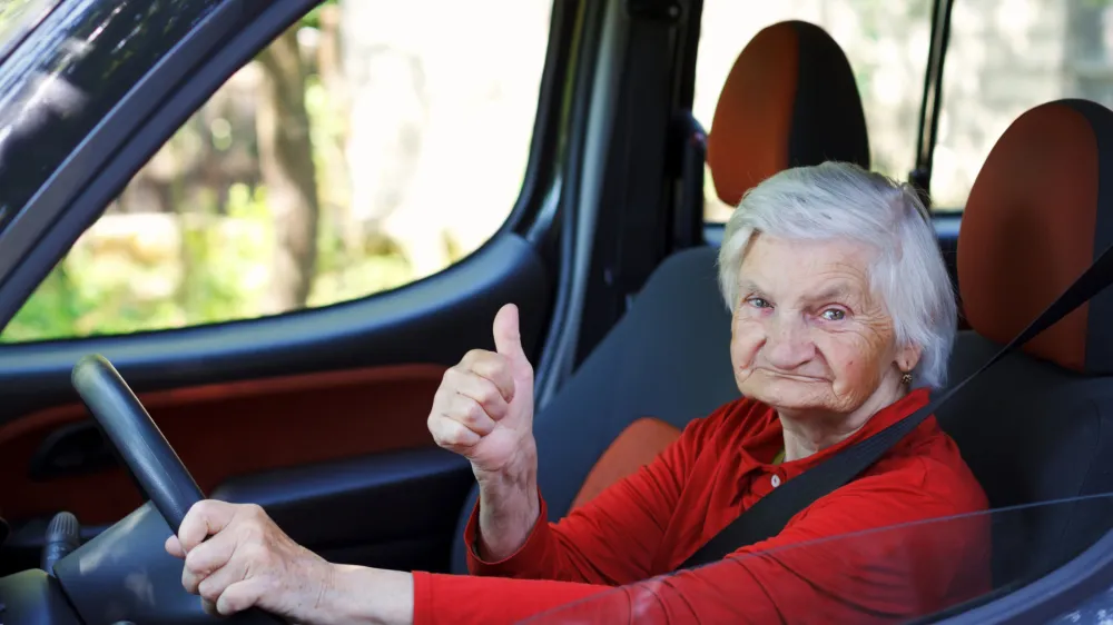Picture of a confident senior woman driving a car