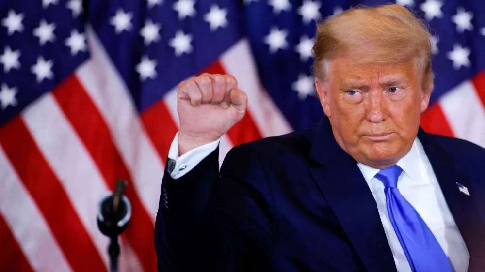 FILE PHOTO: U.S. President Donald Trump raises his fist as he reacts to early results from the 2020 U.S. presidential election in the East Room of the White House in Washington, U.S., November 4, 2020. REUTERS/Carlos Barria/File Photo