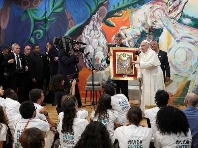 Pope Francis accompanied by Scholas Occurrentes director Jose Maria del&nbsp;Corral speaks to young students during a visit to Scholas Occurrentes in Cascais, Portugal, 03 August 2023. The Pontiff will be in Portugal on the occasion of World Youth Day (WYD), one of the main events of the Church that gathers the Pope with youngsters from around the world, that takes place until 06 August. ANTONIO COTRIM/Pool via REUTERS