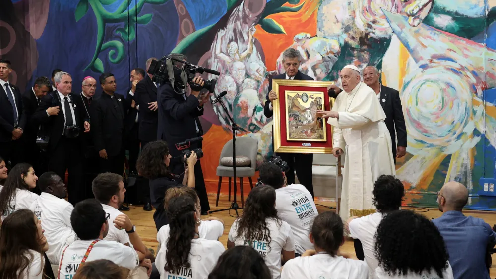 Pope Francis accompanied by Scholas Occurrentes director Jose Maria del&nbsp;Corral speaks to young students during a visit to Scholas Occurrentes in Cascais, Portugal, 03 August 2023. The Pontiff will be in Portugal on the occasion of World Youth Day (WYD), one of the main events of the Church that gathers the Pope with youngsters from around the world, that takes place until 06 August. ANTONIO COTRIM/Pool via REUTERS