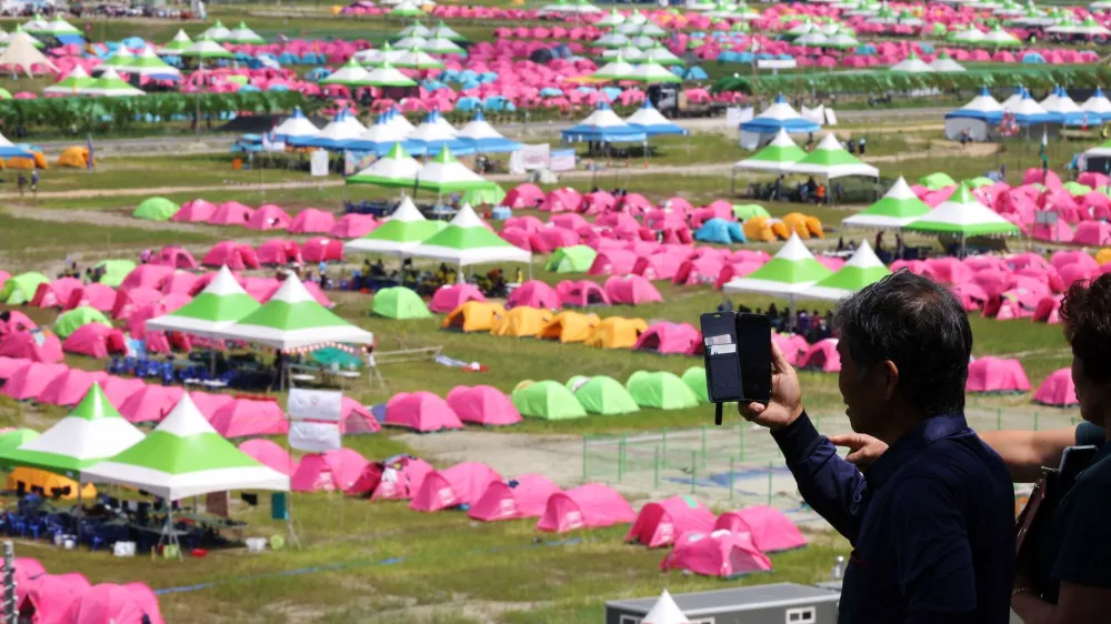 A resident films the camping site for the 25th World Scout Jamboree in Buan, South Korea, August 4, 2023.  REUTERS/Kim Hong-Ji