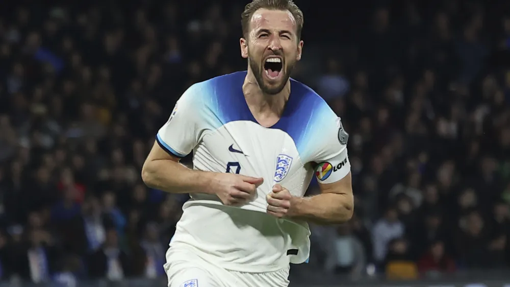 FILE - England's Harry Kane celebrates after scoring to 0-2 during the Euro 2024 group C qualifying soccer match between Italy and England at the Diego Armando Maradona stadium in Naples, Italy, Thursday, March 23, 2023. Harry Kane has a career-defining decision to make. The England captain must choose whether to stay at Tottenham or move to German giant Bayern Munich. The clubs reportedly have reached an agreement regarding the transfer of Kane for a deal worth more than 100 million euros ($110 million) and now it is over to the striker to decide. (Alessandro Garofalo/Lapresse via AP, File)