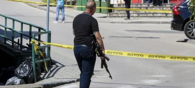 A plain-clothes police officer holds a rifle as they launch a major chase for a man who claimed to have shot and killed his wife while broadcasting it live on Instagram, in the small town of Gradacac, Bosnia, Friday, Aug. 11, 2023. (AP Photo)