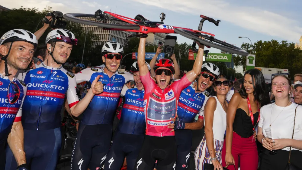 Belgian Remco Evenepoel of Quick-Step Alpha Vinyl, center, celebrates with teammates after winning the Vuelta cycling race, in Madrid, Spain, Sunday, Sept. 11, 2022. (AP Photo/Manu Fernandez)