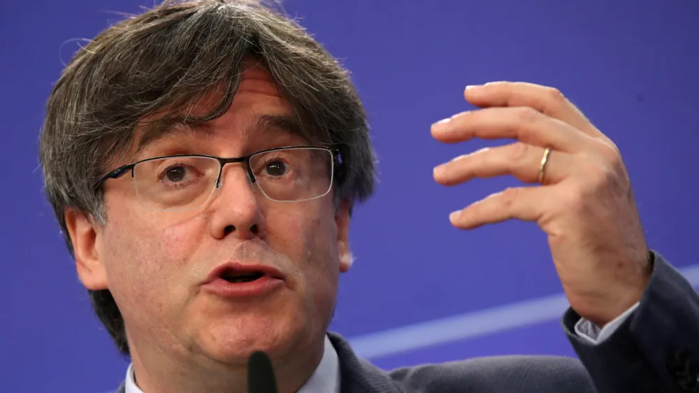 ﻿FILE PHOTO: Catalan MEP Carles Puigdemont gestures during a joint news conference with Catalan MEPs Antoni Comin and Clara Ponsati regarding their immunity at the European Parliament, in Brussels, Belgium June 3, 2021. REUTERS/Yves Herman/File Photo