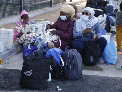 Migrants wait to board a flight in Misrata, Libya, Monday, Oct. 24, 2022. The Libyan authorities, in cooperation with the International Organization for Migration (IOM), repatriated 141 Nigerian migrants from the city of Misrata on Monday, as part of a program to resume voluntary flights to deport migrants. (AP Photo/Yousef Murad)