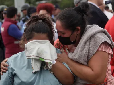 The relative of an inmate reacts while another person tries to comfort her as they wait for news about their loved ones outside the Centro Femenino de Adaptacion Social (CEFAS) women's prison following deadly riot in Tamara, on the outskirts of Tegucigalpa, Honduras, June 20, 2023. REUTERS/Fredy Rodriguez