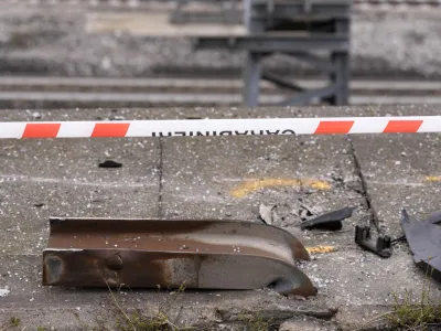 Wreckage of a damaged guardrail lies on the road at the scene of a passenger bus accident in Mestre, near the city of Venice, Italy, Wednesday, Oct. 4, 2023. The bus fell from an elevated road, late Tuesday, killing multiple people. (AP Photo/Antonio Calanni)
