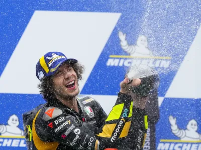 Italy's Marco Bezzecchi, of Ducati Mooney VR46 Racing, celebrates on the podium winning the Moto GP race in Termas de Rio Hondo, Argentina, Sunday, April 2, 2023. (AP Photo/Natacha Pisarenko)