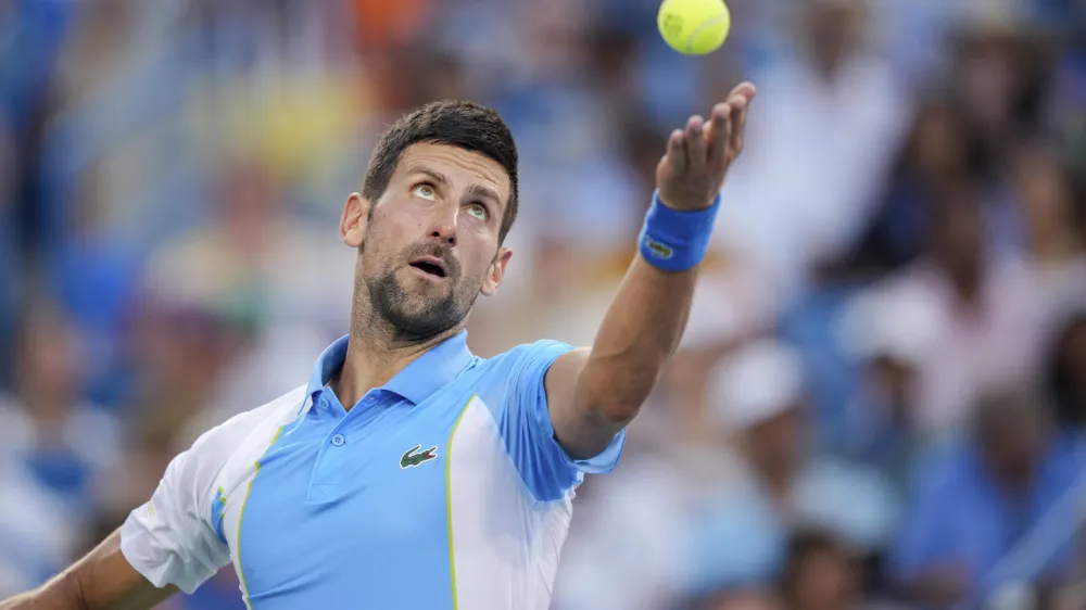 Novak Djokovic, of Serbia, serves to Carlos Alcaraz, of Spain, during the men's singles final of the Western & Southern Open tennis tournament, Sunday, Aug. 20, 2023, in Mason, Ohio. (AP Photo/Aaron Doster)