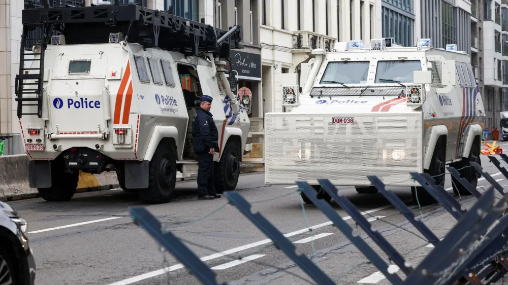 An officer stands next to an armored vehicle, on the day of European Union leaders summit, in Brussels, Belgium October 26, 2023. REUTERS/Yves Herman