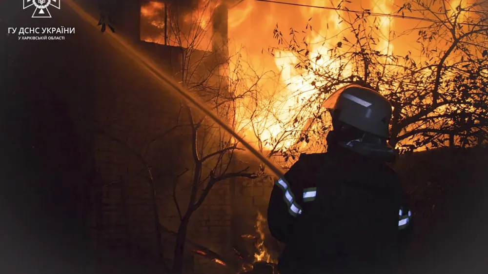 In this photo provided by the Ukrainian Emergency Service, emergency services personnel work to extinguish a fire in Kharkiv, Ukraine, on Friday, Nov. 3, 2023, following Russian drones attack. No casualties have been reported. (Ukrainian Emergency Service via AP)