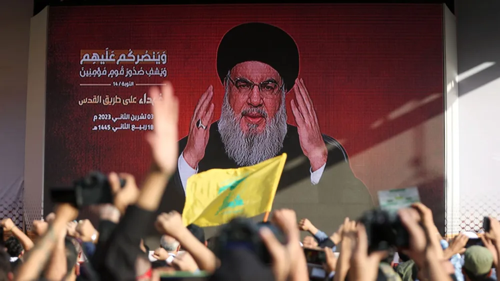 Lebanon's Hezbollah leader Sayyed Hassan Nasrallah appears on a screen as he addresses his supporters during a ceremony to honour fighters killed in the recent escalation with Israel, in Beirut's southern suburbs, Lebanon November 3, 2023. REUTERS/Mohamed Azakir