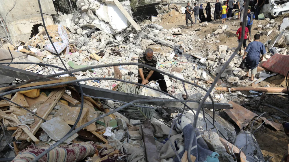 Palestinians inspect the damage of a destroyed house following Israeli airstrikes on Gaza City, Wednesday, Nov. 8, 2023. (AP Photo/Abed Khaled)