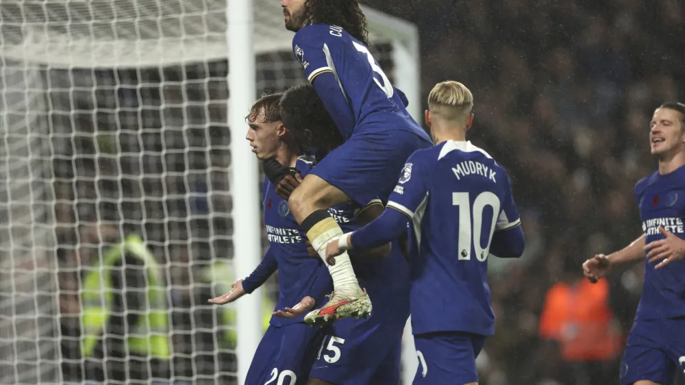 Chelsea players celebrate after Chelsea's Cole Palmer scored his side's fourth goal during the English Premier League soccer match between Chelsea and Manchester City at Stamford Bridge stadium in London, Sunday, Nov. 12, 2023. (AP Photo/Ian Walton)