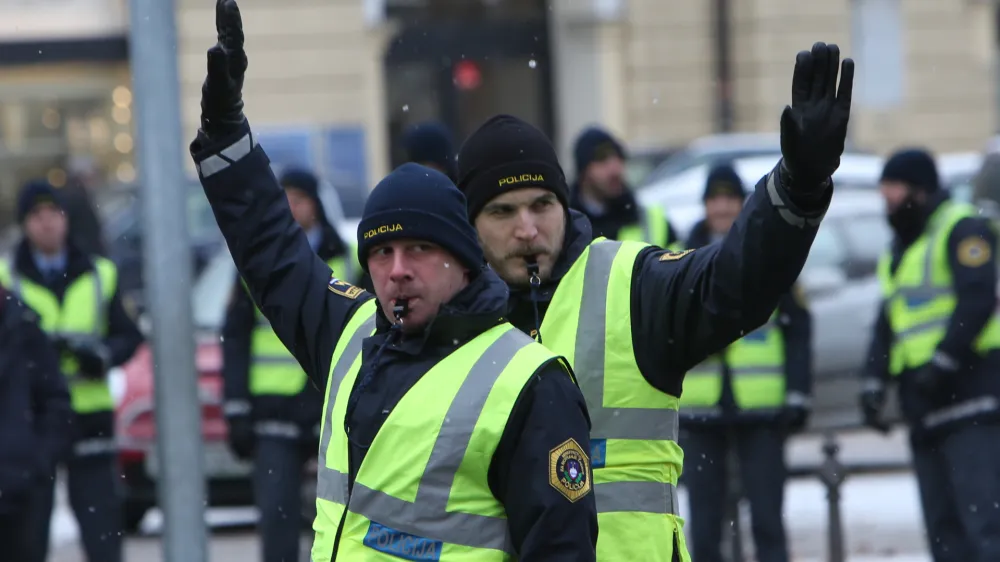 ﻿- 10.01.2017 - Policija - policist prometnik fizično ureja promet v križišču - usmerjanje pretoka prometa skozi križišče - promet v Ljubljani - //FOTO: Tomaž Skale