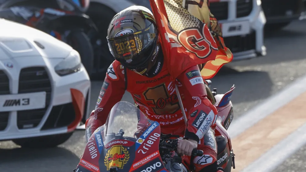 Moto GP World Champion Italian rider Francesco Bagnaia of the Ducati Lenovo Team celebrates after the MotoGP race of the Valencia Motorcycle Grand Prix, the last race of the season, at the Ricardo Tormo circuit in Cheste near Valencia, Spain, Sunday, Nov. 26, 2023. (AP Photo/Alberto Saiz)