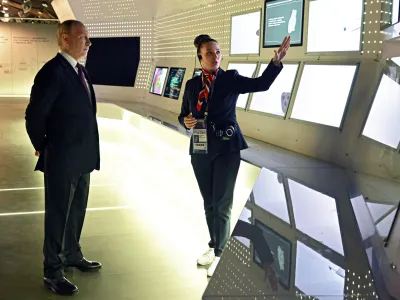 Russian President Vladimir Putin, left, visits the International exhibition "Russia" at VDNKh (The Exhibition of Achievements of National Economy) in Moscow, Russia, Monday, Dec. 4, 2023. (Stanislav Krasilnikov, Sputnik, Kremlin Pool Photo via AP)