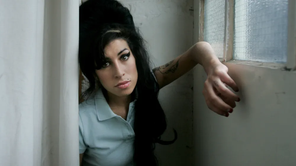 FILE - In this Feb. 16, 2007 file photo, British singer Amy Winehouse poses for a photograph at a studio in north London, Friday, Feb. 16, 2007. British police say singer Amy Winehouse has been found dead at her home in London on Saturday, July 23, 2011. The singer was 27 years old. (AP Photo/Matt Dunham, File)
