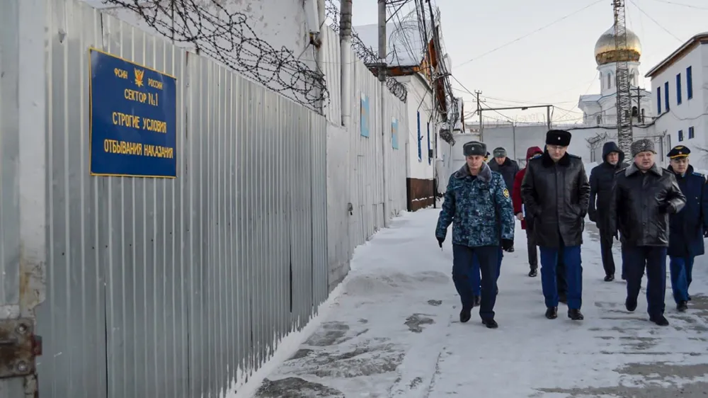 In this photo released by Human rights ombudsman of Yamalo-Nenets Autonomous District on Friday, Dec. 15, 2023, a group of officers walk inside a prison colony in the town of Kharp, in the Yamalo-Nenetsk region about 1,900 kilometers (1,200 miles) northeast of Moscow. Associates of imprisoned Russian opposition leader Alexei Navalny say he has been located at a prison colony above the Arctic Circle nearly three weeks after contact with him was lost. (Human rights ombudsman of Yamalo-Nenets Autonomous District via AP)