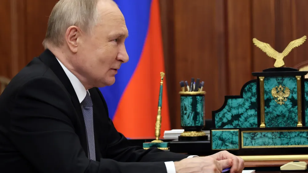 Russian President Vladimir Putin listens to Aeroflot Russian air company chairman and CEO Sergei Aleksandrovsky during their meeting at the Kremlin, in Moscow, Russia, Friday, Dec. 29, 2023. (Gavriil Grigorov, Sputnik, Kremlin Pool Photo via AP)
