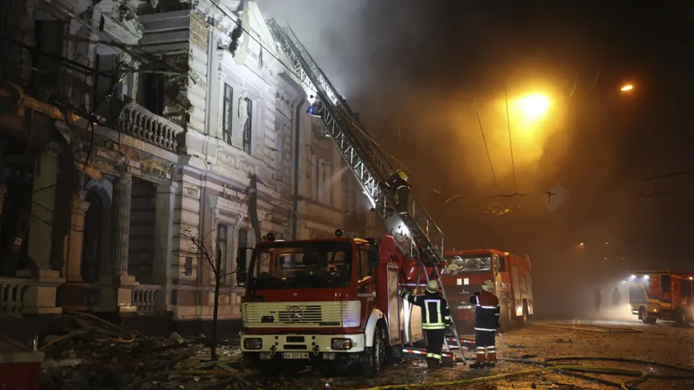 In this photo provided by the Ukrainian Emergency Service, firefighters put out a fire after Russia's missile attack in Kharkiv, Ukraine, Sunday, Dec. 31, 2023. (Ukrainian Emergency Service via AP)