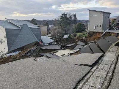 A view of a collapsed road and houses because of an earthquake in Wajima, Ishikawa prefecture, Japan January 2, 2024, in this photo released by Kyodo. Mandatory credit Kyodo via REUTERS ATTENTION EDITORS - THIS IMAGE WAS PROVIDED BY A THIRD PARTY. MANDATORY CREDIT. JAPAN OUT. NO COMMERCIAL OR EDITORIAL SALES IN JAPAN