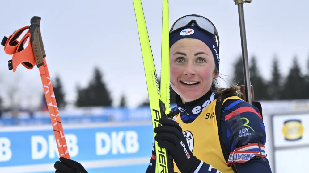 Justine Braisaz-Bouchet of France smiles after crossing a finish line during the Biathlon World Cup women's 7.5 km sprint in Oberhof, Germany, Friday, Jan. 5, 2024. (Martin Schutt/dpa via AP)