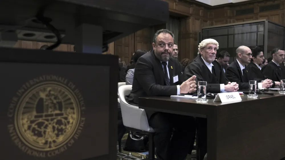 British jurist Malcolm Shaw, second left, legal adviser to Israel's Foreign Ministry Tal Becker, left, look on during the opening of the hearings at the International Court of Justice in The Hague, Netherlands, Thursday, Jan. 11, 2024. The United Nations' top court opens hearings Thursday into South Africa's allegation that Israel's war with Hamas amounts to genocide against Palestinians, a claim that Israel strongly denies. (AP Photo/Patrick Post)