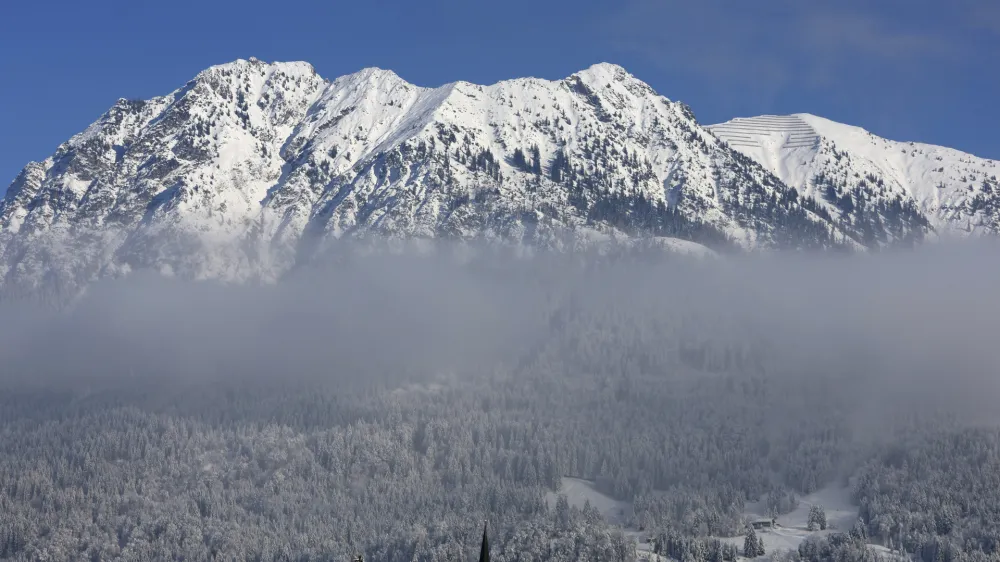 A view of mountains with the church of St. John the Baptist, bottom centre, in Oberstdorf, Bavaria, Germany, Jan. 9, 2024. (Karl-Josef Hildenbrand/dpa/dpa via AP)