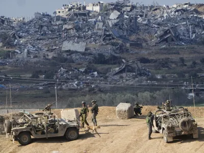 Israeli soldiers take up positions near the Gaza Strip border, in southern Israel, Friday, Dec. 29, 2023. The army is battling Palestinian militants across Gaza in the war ignited by Hamas' Oct. 7 attack into Israel. Israel and Hamas have been at war for 100 days. The war already is the longest and deadliest between Israel and the Palestinians since Israel's establishment in 1948, and the fighting shows no signs of ending. (AP Photo/Ariel Schalit, File)