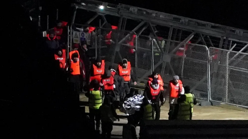 13 January 2024, United Kingdom, Dover: A group of people thought to be migrants are brought in to Dover, Kent, onboard a Border Force vessel following a small boat incident in the English Channel. Photo: Gareth Fuller/PA Wire/dpa