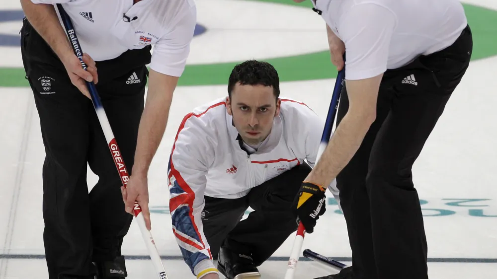 Great Britain skip David Murdoch releases the stone as Euan Byers, left, and Pete Smith, gets set to sweep in their loss to Canada in men's curling at the Vancouver 2010 Olympics in Vancouver, British Columbia, Saturday, Feb. 20, 2010. (AP Photo/Robert F. Bukaty)