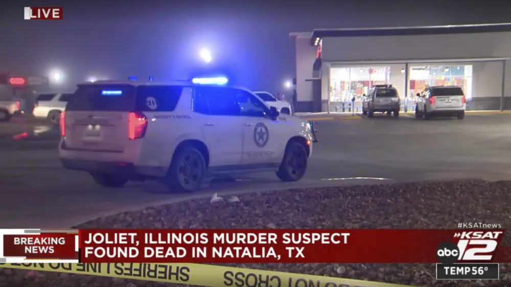 In this image taken from video provided by KSAT-TV ABC 12, authorities stage at a gas station in Natalia, Texas, late Monday, Jan. 22, 2024. A man suspected of shooting and killing multiple people in suburban Chicago fatally shot himself at the gas station after a confrontation with law enforcement officials, police said. (KSAT-TV ABC 12 via AP)