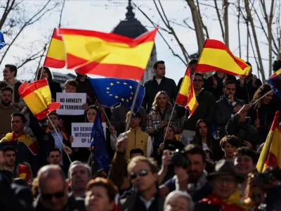 Demonstrators wave Spanish and EU flags during a protest against the Socialist government of Pedro Sanchez and its agreements with Catalan separatist parties over an amnesty law, in Plaza Espana, Madrid, Spain, January 28, 2024. REUTERS/Isabel Infantes
