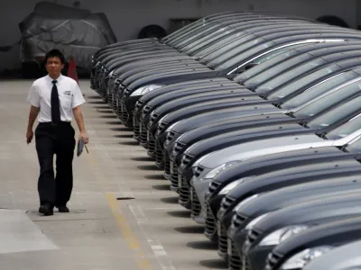 ﻿A man walks past brand new cars at a car dealer in Shanghai, China, Wednesday June 8, 2011. Foreign automakers are seeing mixed sales trends in China as the world's biggest market for new vehicles cools after years of torrid growth. (AP Photo/Eugene Hoshiko)
