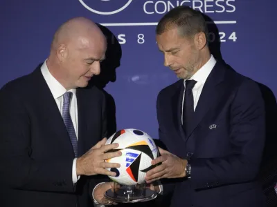 UEFA President Aleksander Ceferin, right, and FIFA President Gianni Infantino pose during the 48th UEFA congress in Paris, Thursday, Feb. 8, 2024. (AP Photo/Christophe Ena)